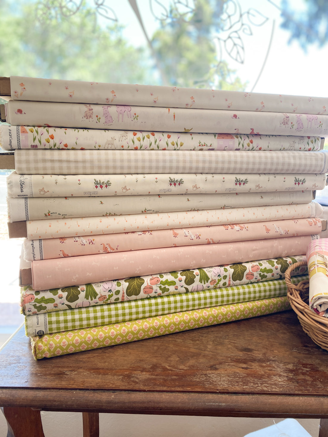 Stack of whimsical fabric bolts on a table
