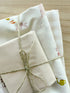 Fabric bundle with bunnies, geese, vegetables, watering cans, with light pink and cream tied with twine